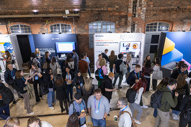 Attendees exploring the partner booths on the UXDX expo floor