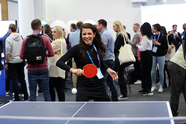 Attendee playing table tennis between sessions at UXDX